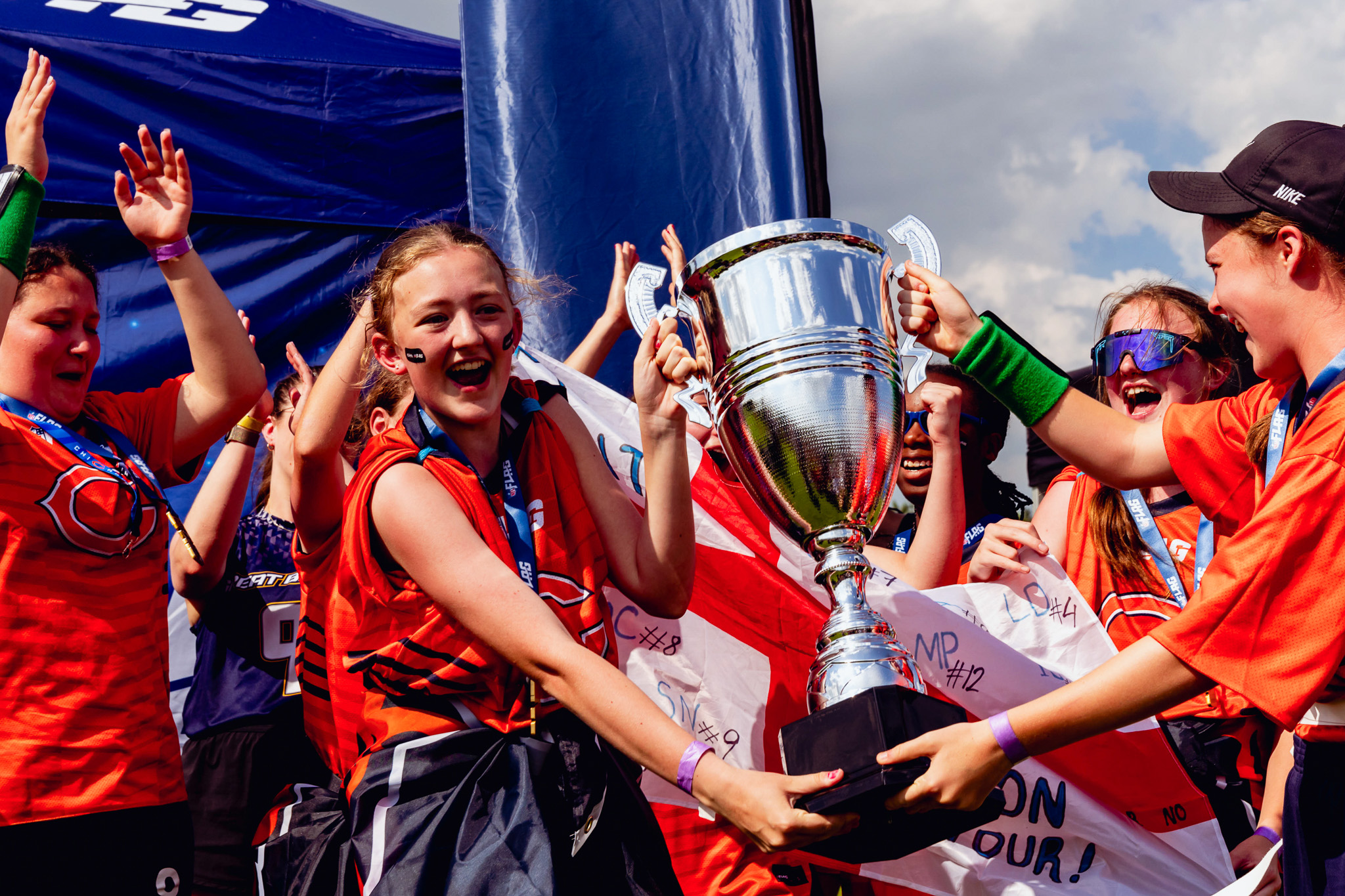 NFL Flag UK - group photo of a team at the 2024 National Flag Championships, holding their trophy and smiling.